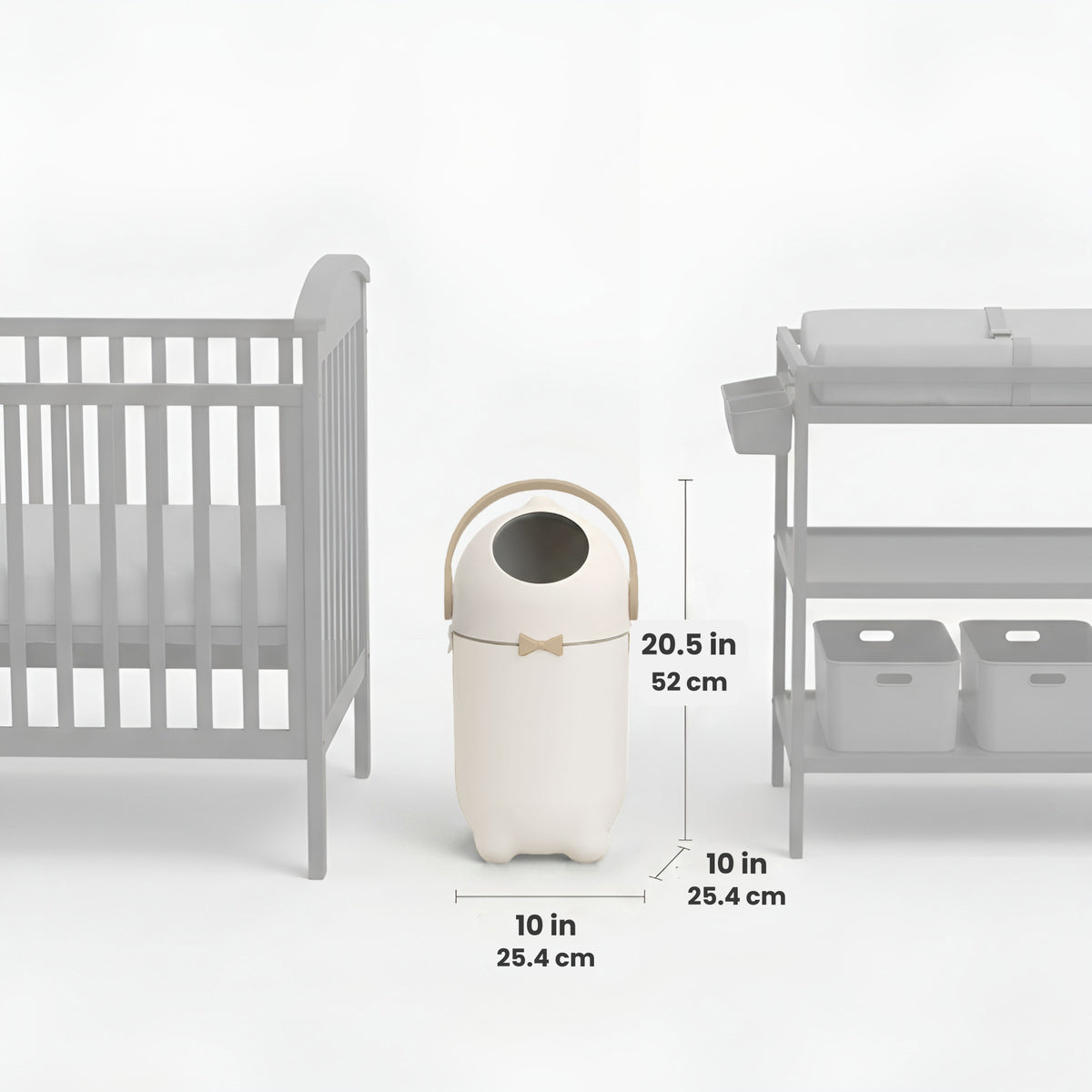 iTouchless Odor-Free Diaper Pail shown centered between a crib and a changing table, with labeled dimensions. The pail measures 20.5 inches tall (52 cm) and 10 inches wide and deep (25.4 cm), illustrating its compact size and nursery-friendly fit.