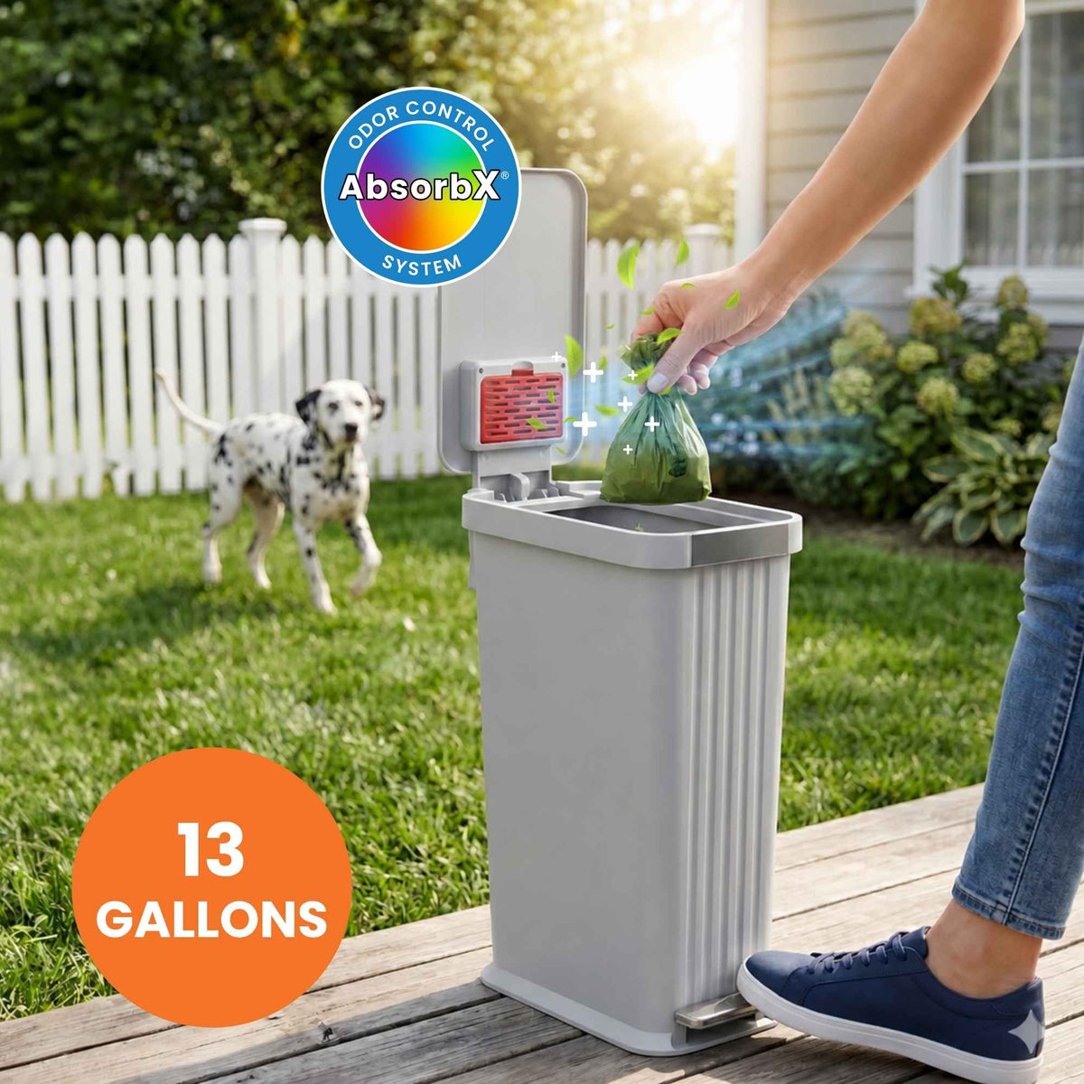 Person disposing of a bag into a 13-gallon trash can with AbsorbX color control system in a backyard setting.